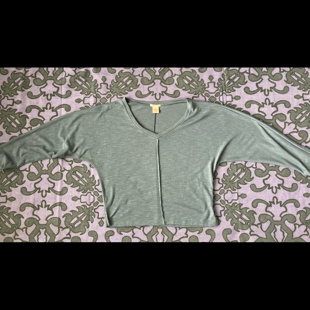 Gray quarter length sleeve sweater.